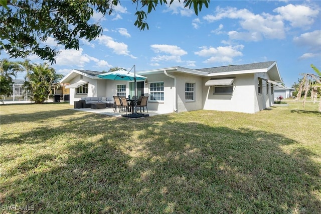 rear view of property featuring a patio, outdoor lounge area, and a lawn