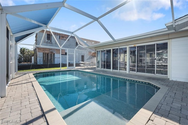 view of swimming pool with a lanai and a patio area