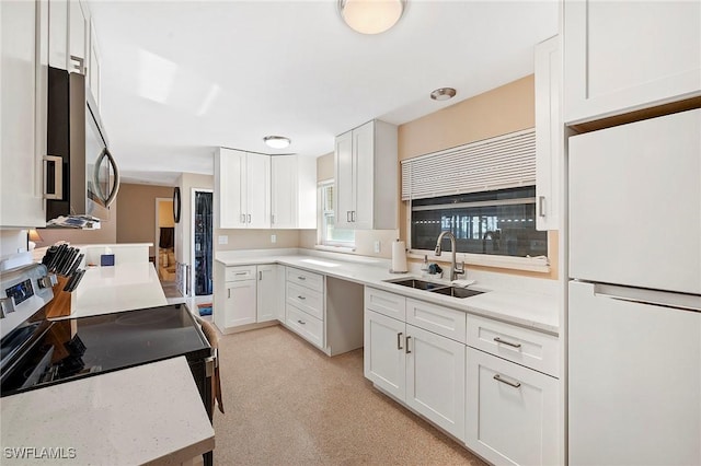 kitchen featuring sink, stainless steel appliances, and white cabinets