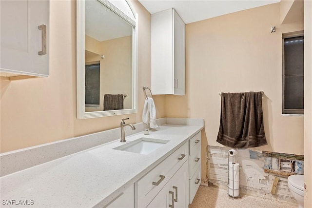 bathroom featuring vanity and toilet