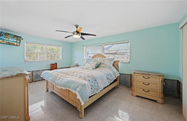 bedroom featuring multiple windows and ceiling fan