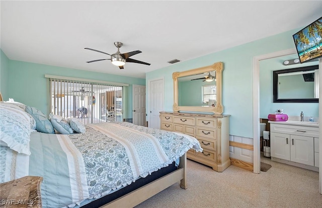 carpeted bedroom with ceiling fan and sink