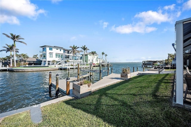 dock area featuring a water view and a yard