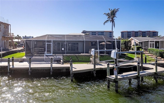 view of dock with a water view and glass enclosure