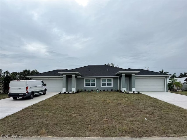 single story home featuring a garage and a front yard