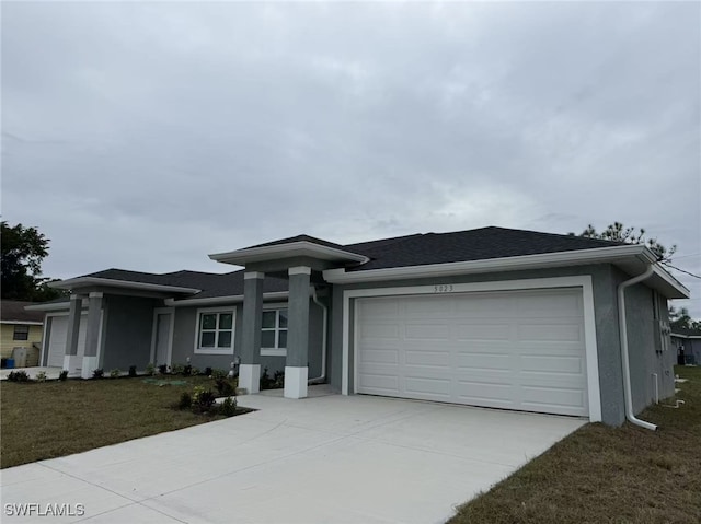 prairie-style house featuring a garage and a front yard