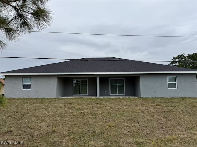 back of property featuring a lawn