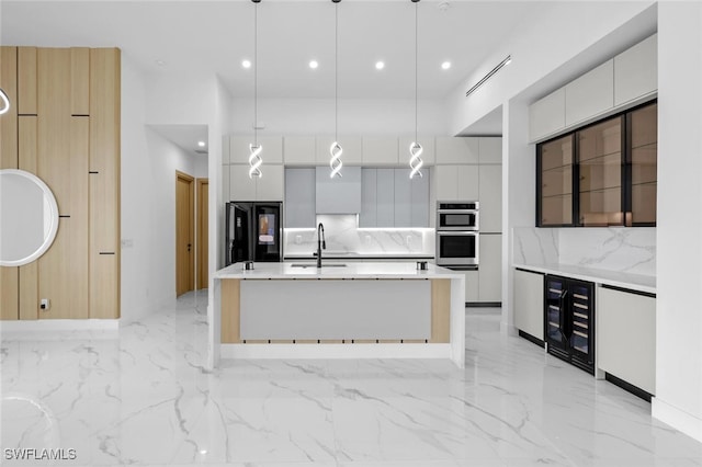 kitchen with pendant lighting, white cabinets, and black refrigerator