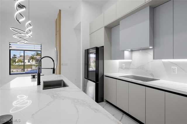 kitchen featuring black appliances, decorative backsplash, sink, white cabinets, and light stone counters