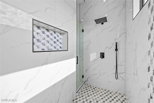 bathroom featuring a shower with door