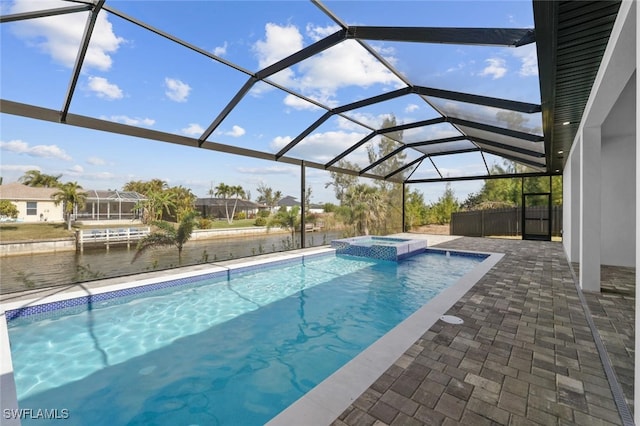 view of swimming pool featuring a lanai, a patio, and an in ground hot tub