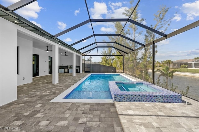 view of pool with ceiling fan, glass enclosure, an in ground hot tub, and a patio