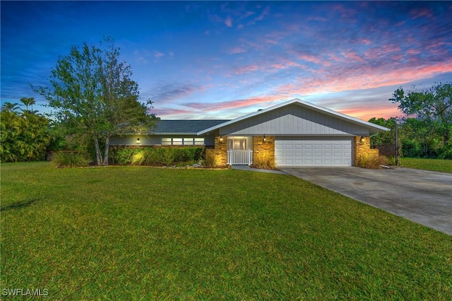 single story home with a garage and a yard