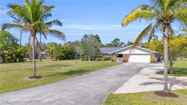 single story home featuring a garage and a front yard