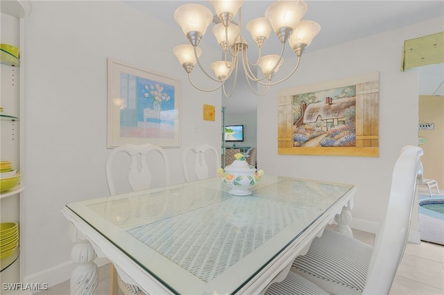 tiled dining room with a chandelier