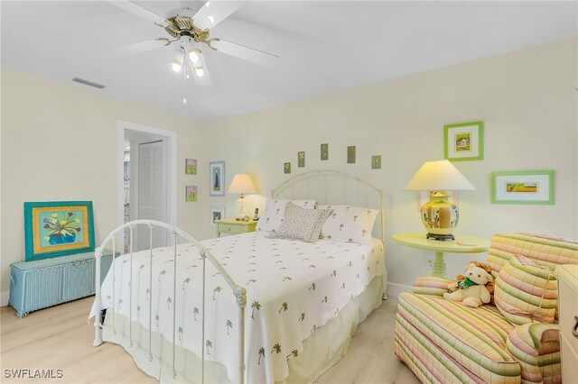 bedroom with light hardwood / wood-style floors and ceiling fan