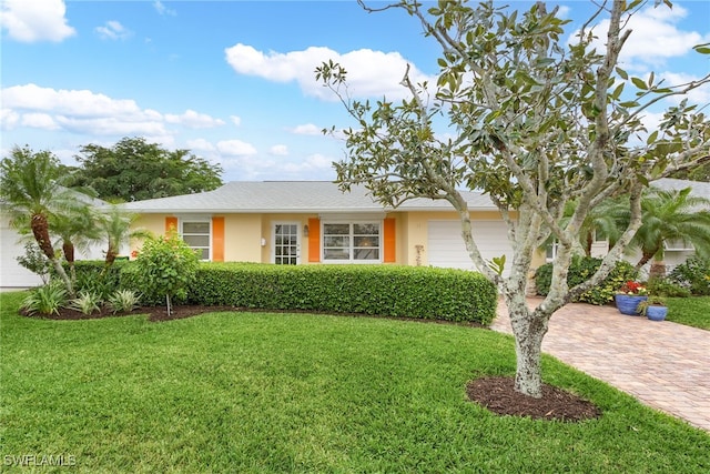 view of front of property featuring a garage and a front lawn