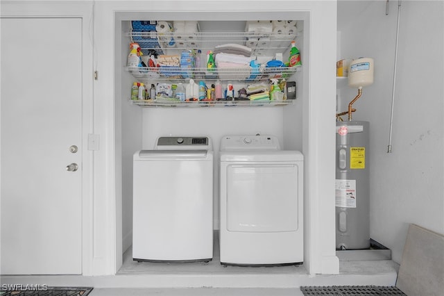 laundry area with separate washer and dryer and water heater