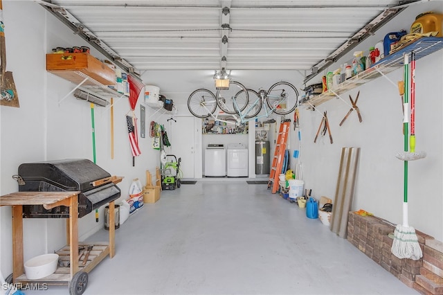 garage with independent washer and dryer and electric water heater