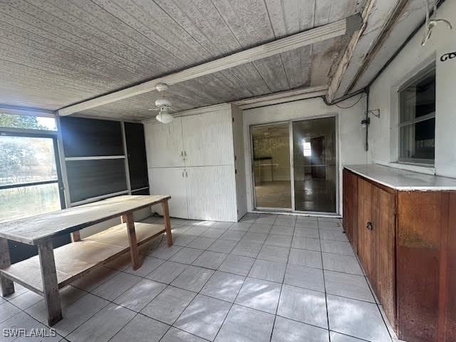 unfurnished dining area featuring light tile patterned flooring