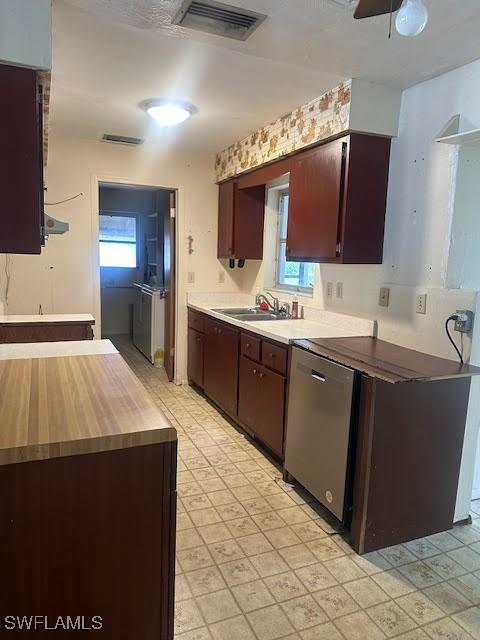 kitchen featuring dishwasher, sink, and ceiling fan