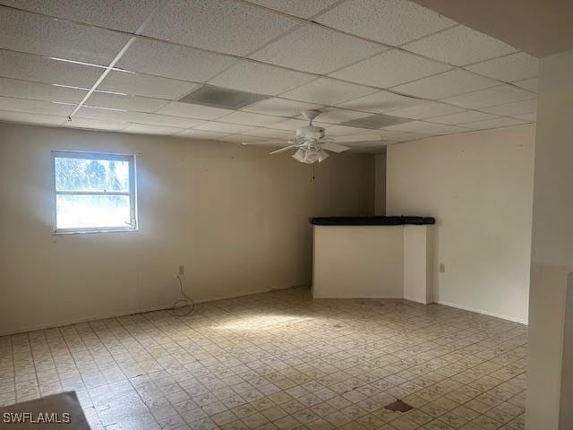 unfurnished room with a paneled ceiling and ceiling fan