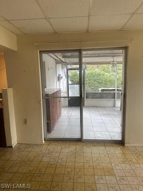 doorway featuring plenty of natural light and a paneled ceiling