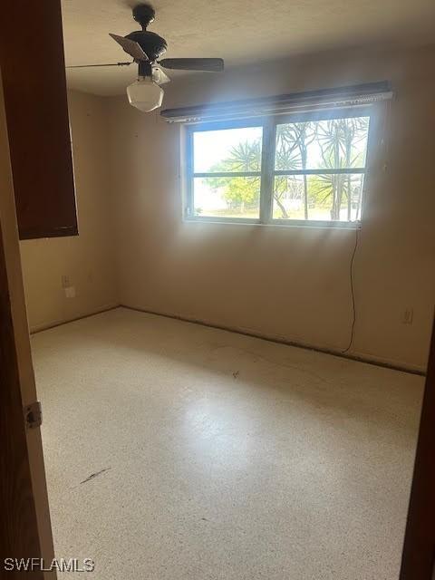 unfurnished room featuring ceiling fan