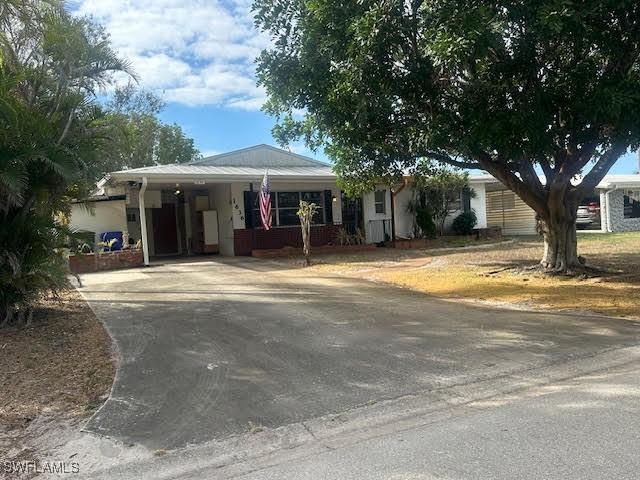 ranch-style home featuring a carport