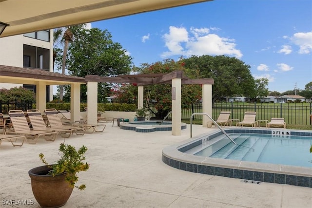 pool with a pergola, a patio area, fence, and a hot tub