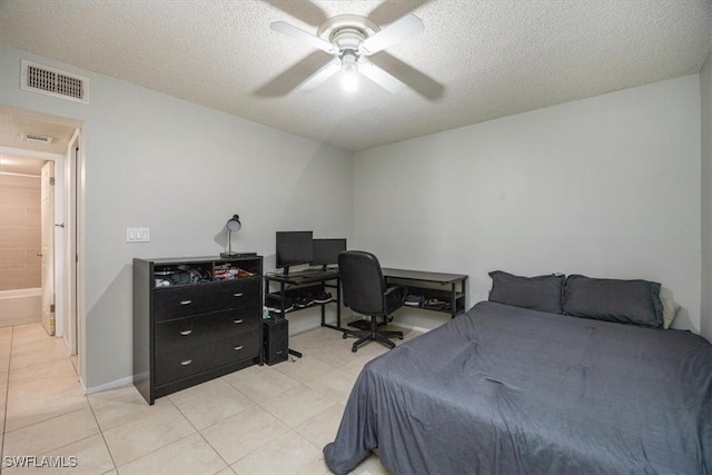 bedroom with light tile patterned floors, a textured ceiling, visible vents, baseboards, and a ceiling fan