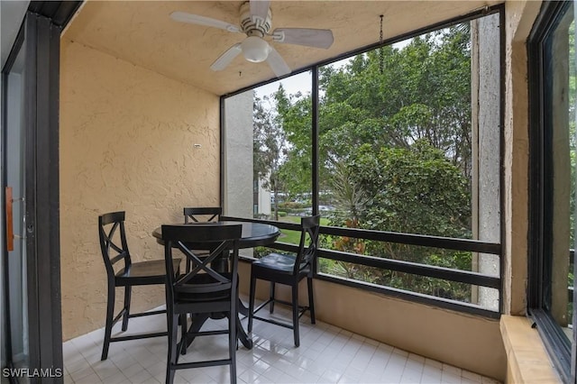 sunroom with ceiling fan and a wealth of natural light