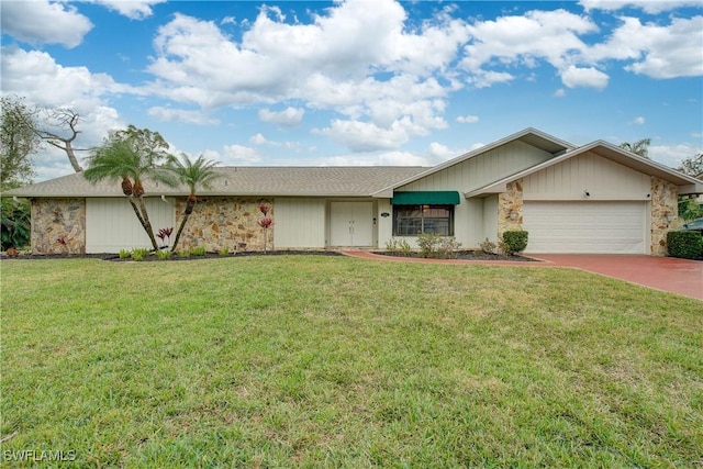 ranch-style home with a garage and a front lawn