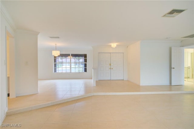 empty room featuring ornamental molding, light tile patterned floors, and a notable chandelier