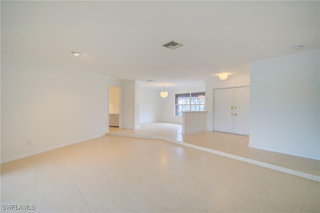 unfurnished room featuring crown molding and light tile patterned floors