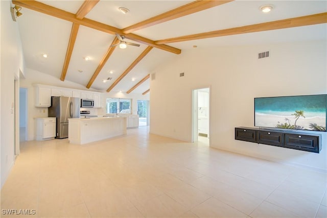 unfurnished living room featuring beam ceiling, ceiling fan, light tile patterned floors, and high vaulted ceiling