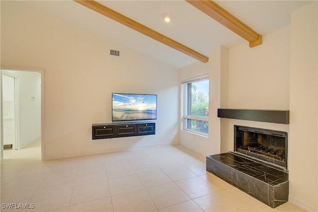 living room with beamed ceiling, a tiled fireplace, high vaulted ceiling, and light tile patterned floors