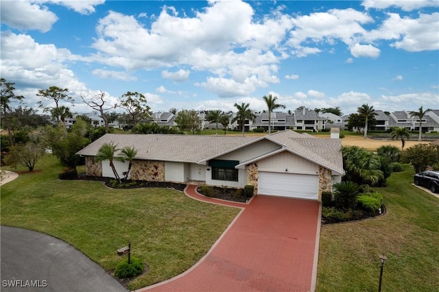 view of front of property featuring a garage and a front lawn