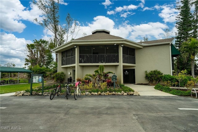 view of front of house featuring a sunroom