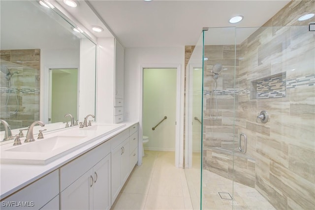 bathroom with tile patterned flooring, walk in shower, vanity, and toilet