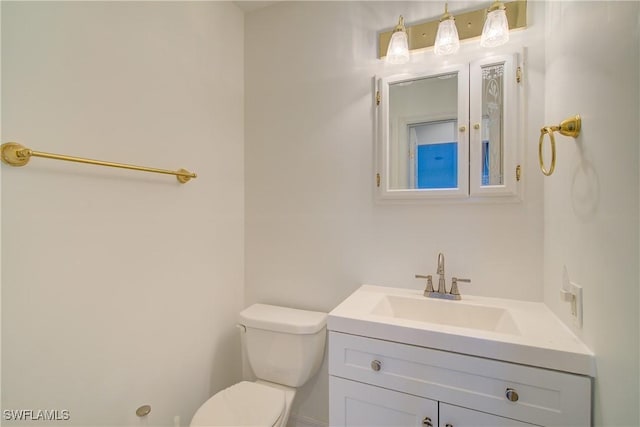 bathroom featuring vanity and toilet