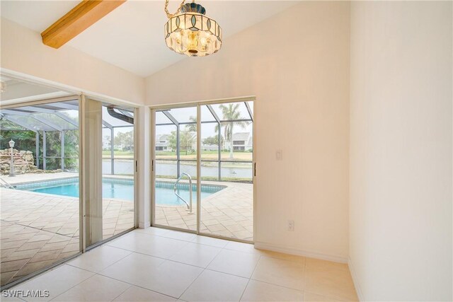 entryway with plenty of natural light, vaulted ceiling with beams, and light tile patterned floors