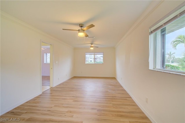 unfurnished room featuring ornamental molding, ceiling fan, and light hardwood / wood-style flooring