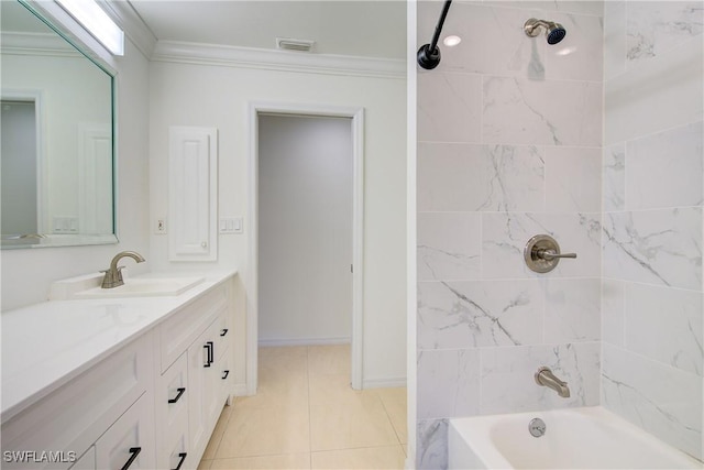 bathroom with tile patterned flooring, tiled shower / bath, ornamental molding, and vanity