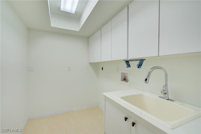 laundry area featuring electric dryer hookup, sink, hookup for a washing machine, and cabinets