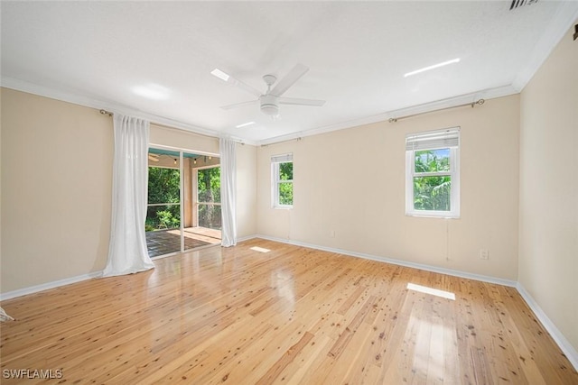 empty room with ceiling fan, a healthy amount of sunlight, ornamental molding, and light wood-type flooring