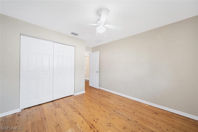 unfurnished bedroom with ceiling fan, light hardwood / wood-style flooring, and a closet