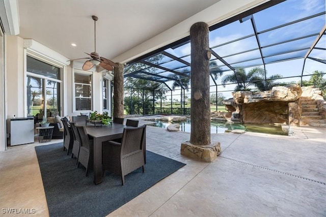 view of patio / terrace with ceiling fan and a lanai