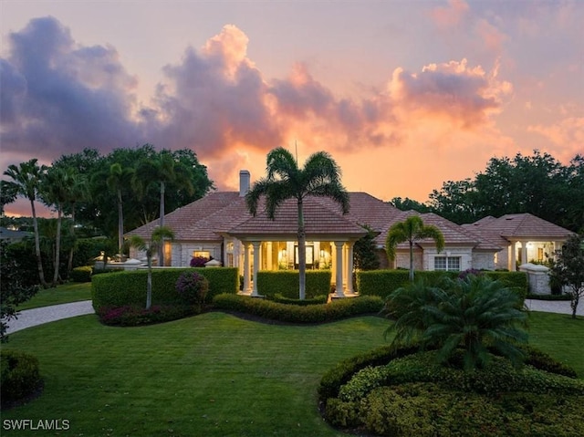 view of front of home with a lawn