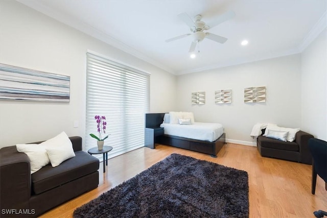 bedroom featuring hardwood / wood-style flooring, ceiling fan, and ornamental molding